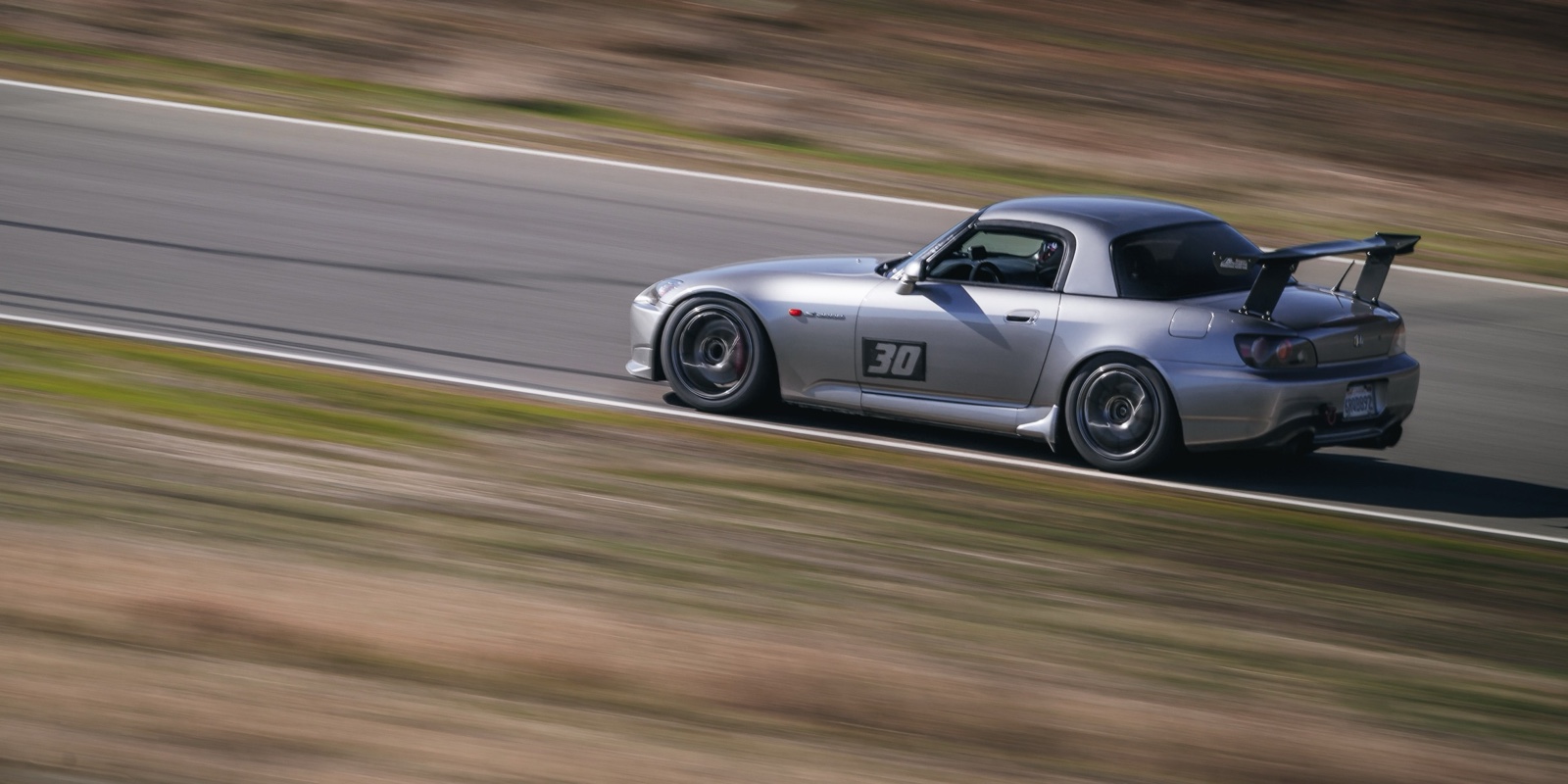 Daniel's silver Honda S2000, number 30, driving at Thunderhill Raceway.